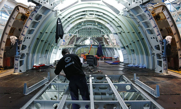 An Airbus employee works inside a fuselage section of an A380 Airbus airplane at the Airbus facility in Montoir-de-Bretagne near Saint-Nazaire